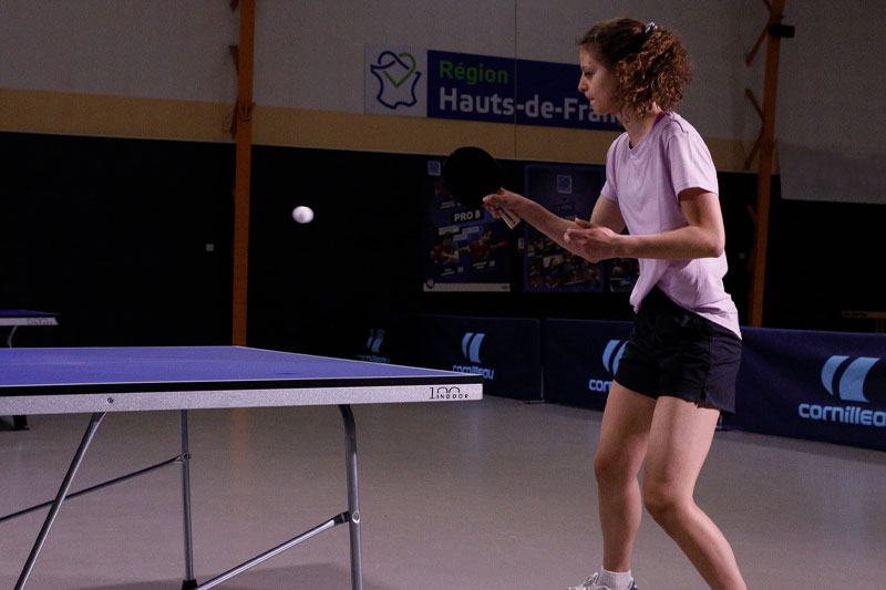 joueuse qui joue sur la table de ping pong Cornilleau 100 indoor